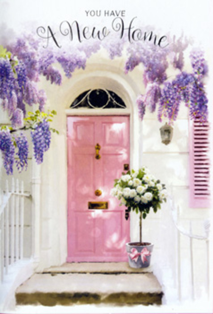 In this image, a modest front entrance is transformed into a romantic celebration of new beginnings, evoking the feel of a Belvedere side street just off Nuxley Road. The focal point is a beautifully painted pink front door, its colour a soft, chalky rose that glows gently against the clean white walls that surround it. The plaster has a subtle texture, catching the light in faint ripples and giving the façade a sense of character and age. Above and around the door, wisteria cascades in abundant lavender clusters, each flower head composed of many tiny petals that hang together like delicate tassels. The trailing vines and leaves weave in and out of view, creating natural arches and curves that soften the architectural lines. At the threshold, placed with obvious care, stands a tin bucket brimming with a hand-crafted floral arrangement. The bucket is filled with full-headed white and cream roses, open just enough to reveal their layered centres, and arranged to form a full, rounded silhouette. The roses' petals look almost velvety, catching hints of the ambient light and reflecting it in soft ivory tones. Among the roses, sprigs of soft greenery add depth, their cooler hues balancing the warmth of the flowers and the pink door. Around the base of the bucket, a pastel pink ribbon has been tied into a loose, flowing bow, its length trailing slightly across the stone step like a gentle, celebratory signature. The entire scene is bathed in warm, diffused sunlight, suggesting a peaceful late afternoon when a same-day delivery from Belvedere Flowers might arrive. The mood is quietly joyful and deeply reassuring, making this arrangement ideal for congratulating someone on a new home, marking an important life transition, or simply reminding them that their doorstep, and their future, are full of beauty.