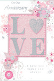 This softly romantic anniversary card mirrors the feeling of a cherished bouquet delivered across Belvedere to mark a special date. At the centre, the word LOVE is elegantly shaped in raised glitter, each letter catching the light in a gentle shimmer. The letter O is transformed into a shimmering heart, richly textured in silver, adding a focal point that feels both playful and deeply affectionate. The surrounding palette is composed of pastel pinks and silvery greys, creating a calm, intimate atmosphere that suggests evenings spent together at home. Delicate, stylised blooms unfold around the central word, their blush and mauve petals washed with an almost watercolour softness. These flowers are traced with fine, flowing lines that suggest light movement, like petals stirred by a faint breeze in a Belvedere garden. Tiny flourishes-small petals, looping swirls, and subtle butterfly shapes-are scattered through the design, adding a sense of motion and quiet joy. The phrases On Our Anniversary and I love you today and always appear in graceful, understated script, their curves echoing the flowing stems and vines. The card's composition feels balanced and thoughtful, much like a hand-arranged anniversary bouquet chosen with care. Every element-the soft colours, shimmering textures, and gentle script-works together to evoke a whisper-soft yet profound declaration of lasting love, perfectly suited to celebrating a shared journey in Belvedere.